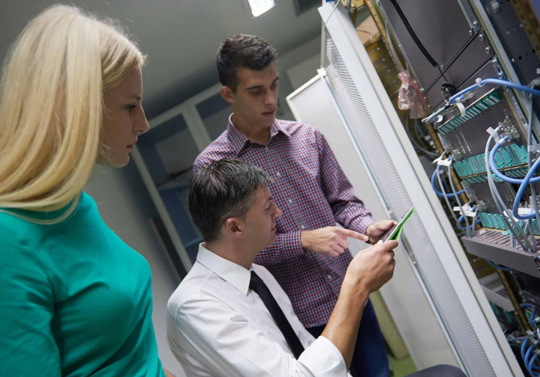 business people group, network engeneers working in network server room on tablet computer